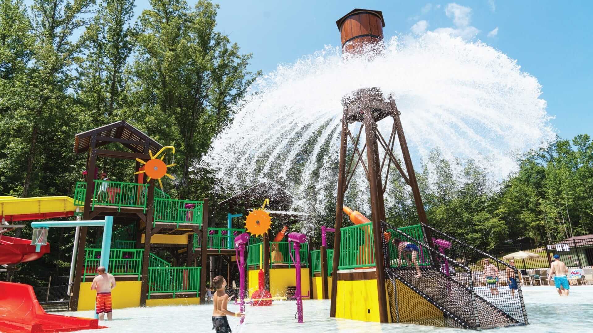 View of the Power Plunge and its 360-degree spray pattern, as kids look on at the water playground at the RV Resort in Bostic, North Carolina.