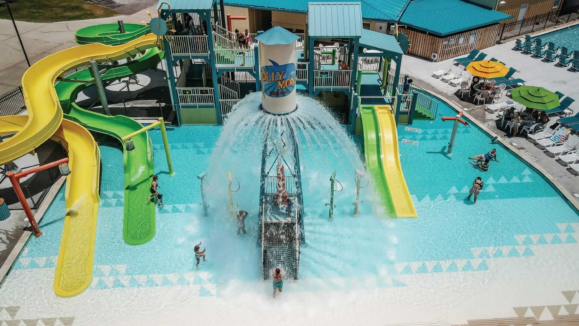 An arial view of the waterpark at Camp Margaritaville RV resort in Henderson Louisiana, which shows the large power plunge feature releasing a large volume of water ask kids rush to get drenched.