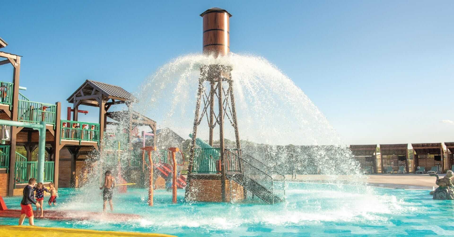 The Power Plunge water feature by Interactive Play releases up to 750 gallons of water in a beautiful 360-degree spray pattern over the pool deck floor at the Camp Fimfo RV Resort in Waco Texas.