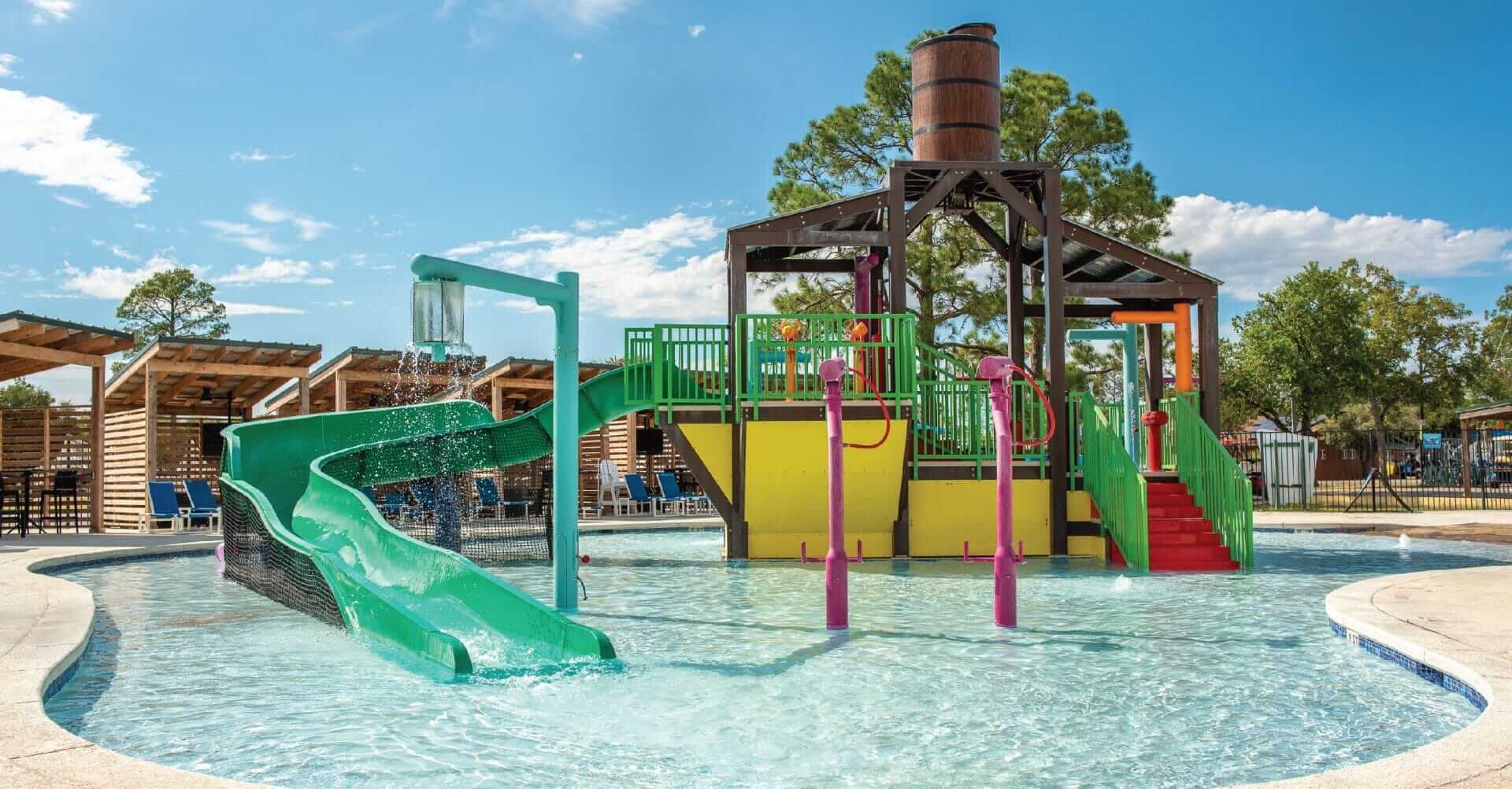 A photo of the aquatic play structure by Interactive play with the power plunge feature releasing a large volume of water at the RV resort in Waller, Texas.