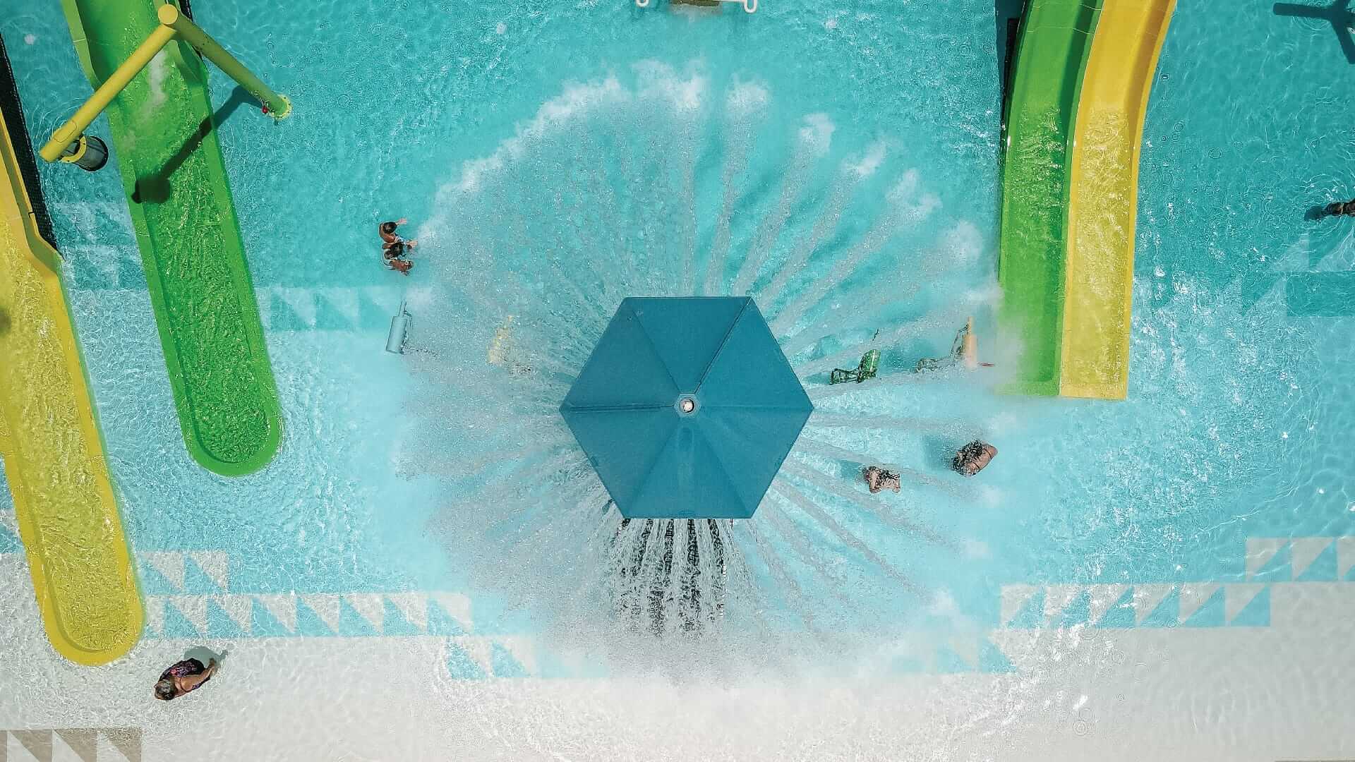 Arial view of the Power Plunge at the Camp Margaritaville RV Resort releasing its 360-degree water spray onto water players below.