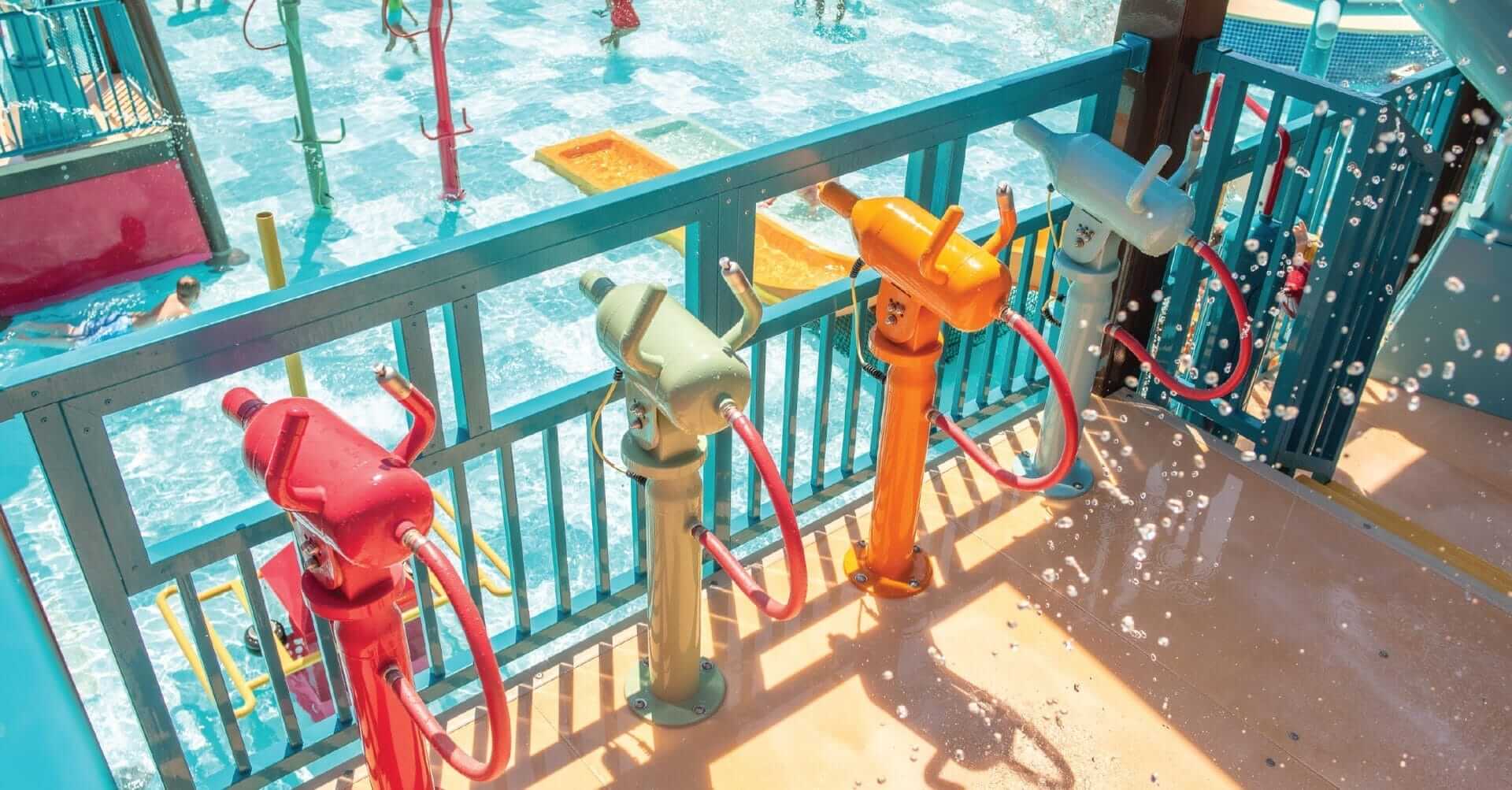 Four rusher water guns shown all in a row at the waterpark in Tyler Texas.